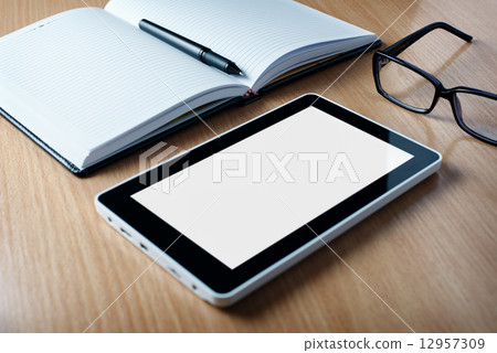 Modern tablet PC next to a classical open agenda Modern tablet PC next to a classical open agenda 12957309
