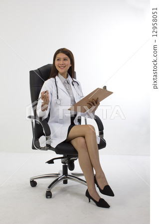 Medical doctor seated in high back chair Medical doctor seated in high back chair 12958051