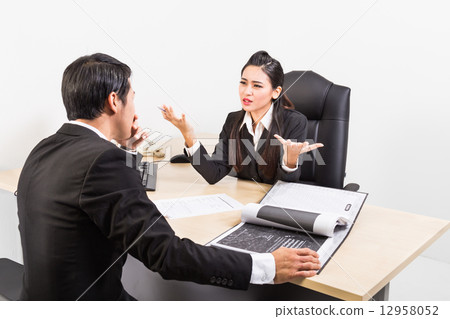 Two business people in serious discussion  12958052