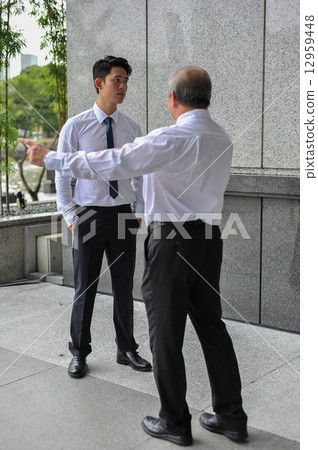 Two Asian men in office in argument / dispute Two Asian men in office in argument / dispute 12959448