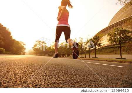 young fitness woman running at sunrise young fitness woman running at sunrise 12964410