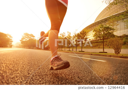 young fitness woman running at sunrise young fitness woman running at sunrise 12964416