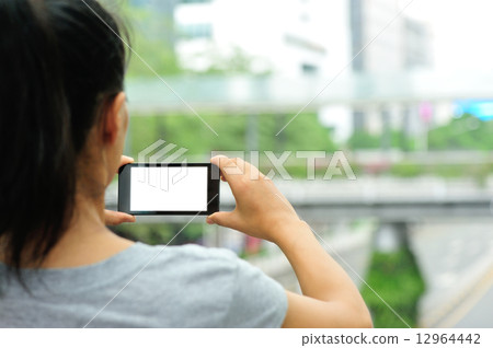 woman hands hold smart phone in modern city woman hands hold smart phone in modern city 12964442