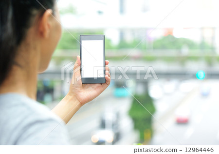 woman hands hold smart phone in modern city woman hands hold smart phone in modern city 12964446