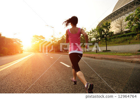 young fitness woman running at sunrise road young fitness woman running at sunrise road 12964764