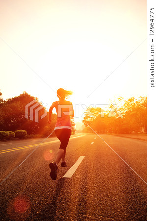 young fitness woman running at sunrise road 12964775