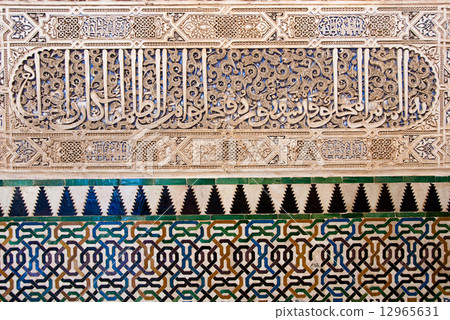 Ancient mosaic pattern at the Alhambra wall, Granada, Spain 12965631