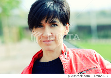 Woman with short hair wearing red jacket Woman with short hair wearing red jacket 12965697