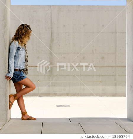 Young woman wearing denim jacket 12965794