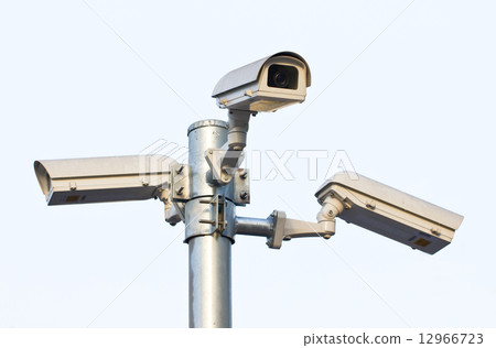Three security cameras against the blue sky. Three security cameras against the blue sky. 12966723