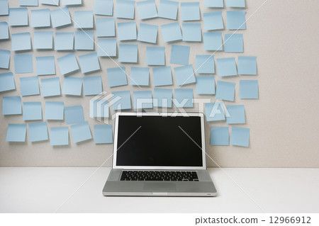 Laptop computer full of sticky notes 12966912
