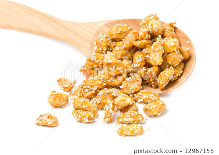 Crispy sugared nuts with wooden spoon isolated on white. Crispy sugared nuts with wooden spoon isolated on white. 12967158