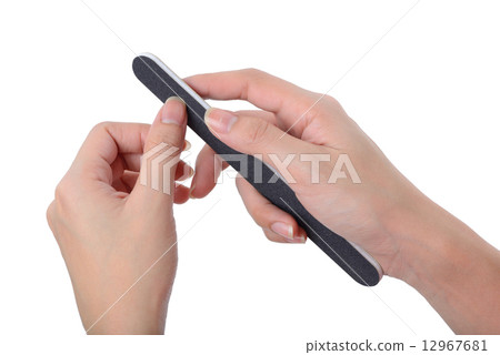 Woman polishing fingernails with nail file 12967681