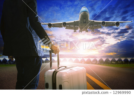 business man and luggage standing in airport and passenger jet p 12969990