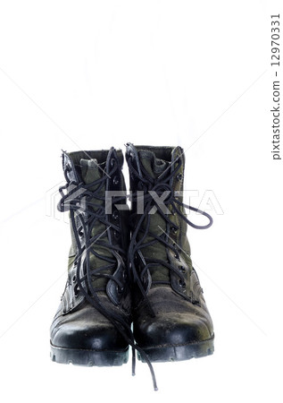Old and dusty combat boots isolated on white. Old and dusty combat boots isolated on white. 12970331