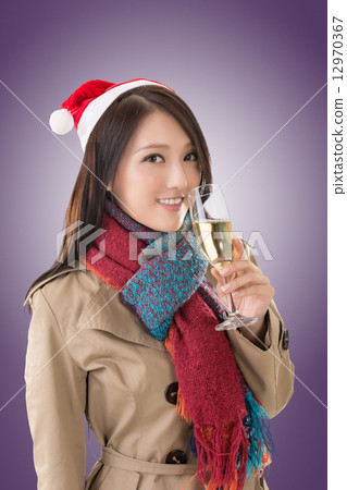 Smiling Asian woman hold a  glass of champagne 12970367
