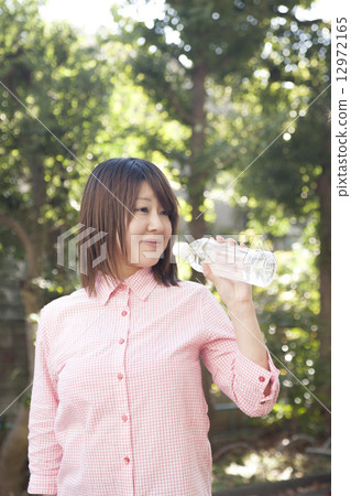 A woman drinking water 12972165