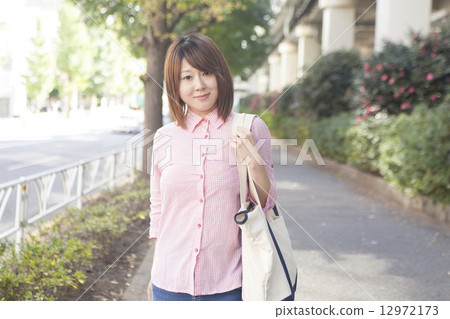 A woman standing on the street 12972173