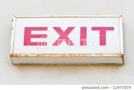 Exit sign on the concrete wall. Exit sign on the concrete wall. 12973879