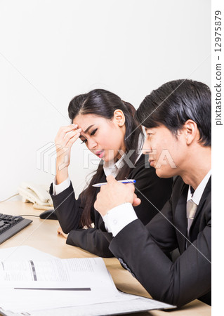 Two business people in serious discussion Two business people in serious discussion 12975879