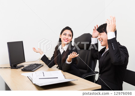 Two business person rejoice upon hearing a piece of good news 12976098