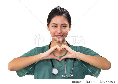 Closed up of a female surgeon's hand making heart shape isolated in white 12977803