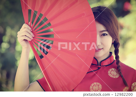 Chinese girl with dress traditional Cheongsam 12982200