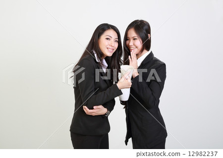Two woman in suit secret discussion over a drink Two woman in suit secret discussion over a drink 12982237