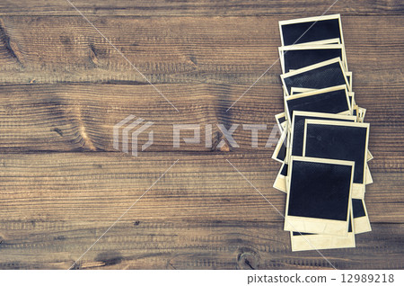 old instant photo frames on rustic wooden background 12989218