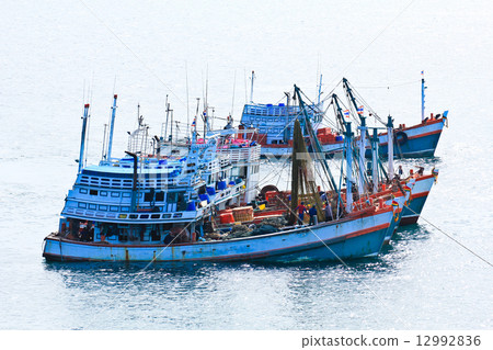 Wooden fishing boat on sea 12992836