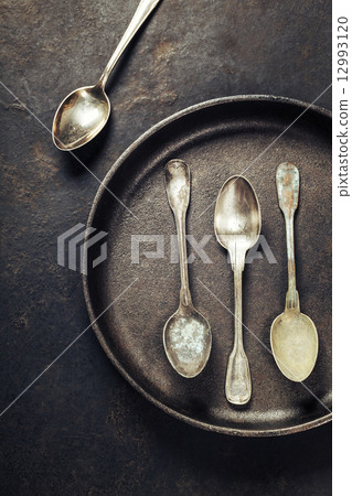 Empty pan with old spoons 12993120