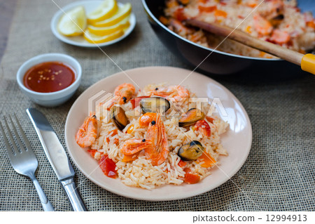 Spanish dish paella with seafood, shrimps in pan Spanish dish paella with seafood, shrimps in pan 12994913