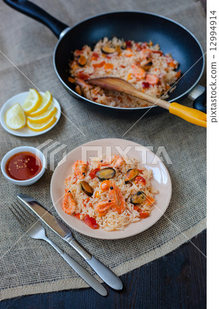 Spanish dish paella with seafood, shrimps in pan Spanish dish paella with seafood, shrimps in pan 12994914