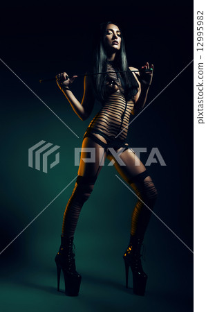 bdsm woman on green background bdsm woman on green background 12995982