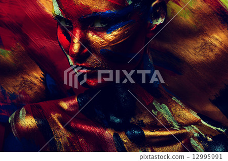 skin of girl in dark colourful paint 12995991