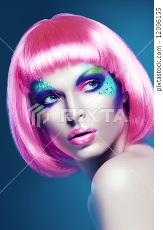 woman in pink wig on blue background woman in pink wig on blue background 12996155