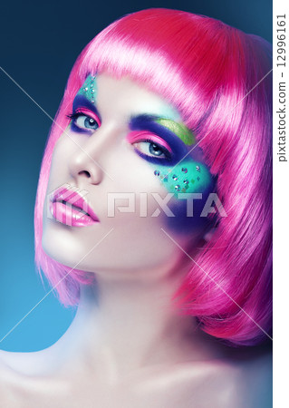 woman with pink wig and colourful make-up 12996161