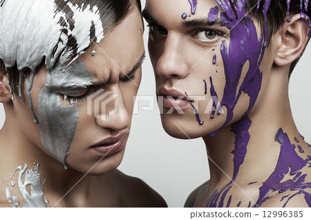 men with silver and violet paint on face men with silver and violet paint on face 12996385
