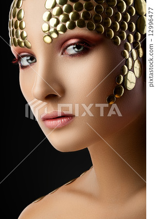 Portrait of a woman with red eyeshadow 12996477