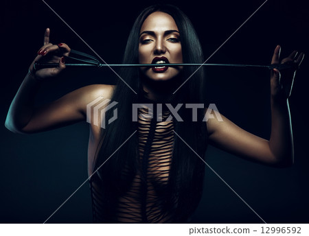 woman with red lips biting whip woman with red lips biting whip 12996592