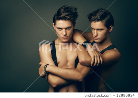 two serious men in suspenders 12996954