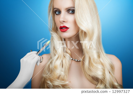 Woman gets an injection in her face 12997327