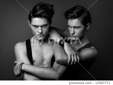 two serious men in suspenders 12997771