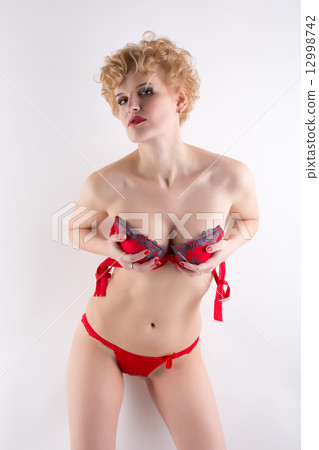 Attractive blonde woman posing in erotic lingerie Attractive blonde woman posing in erotic lingerie 12998742