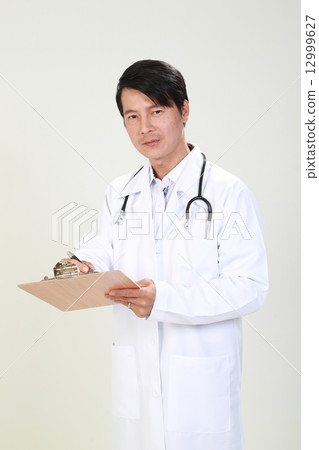 Male Doctor Writing Report on Clipboard Faceing Forward Male Doctor Writing Report on Clipboard Faceing Forward 12999627