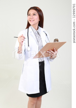 Female Doctor Holding Clipboard and Pen Looking side Female Doctor Holding Clipboard and Pen Looking side 12999701