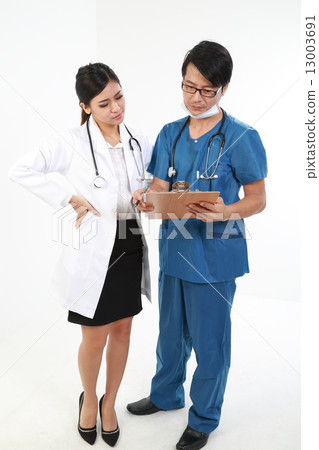Male and female doctor in apron and uniform read report on clipboard Male and female doctor in apron and uniform read report on clipboard 13003691