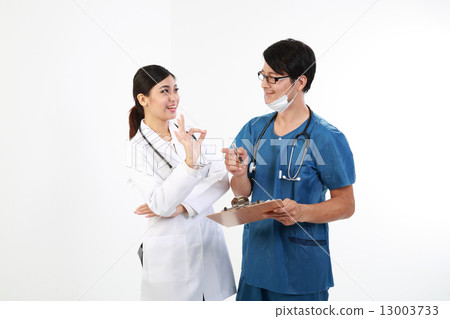 Male and female doctor study report on cleapboard OK happy 13003733