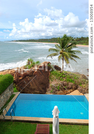 Beach view swimming pool at luxury villa and turquoise water of 13008954
