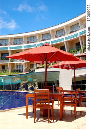 The table and chairs of outdoor restaurant near swimming pool at 13009021